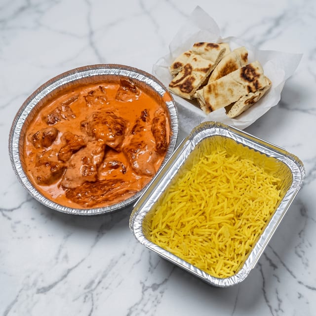 Butter Chicken with Seasoned Yellow Rice & Pita.